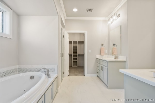 bathroom featuring tile patterned floors, vanity, a bathing tub, and ornamental molding