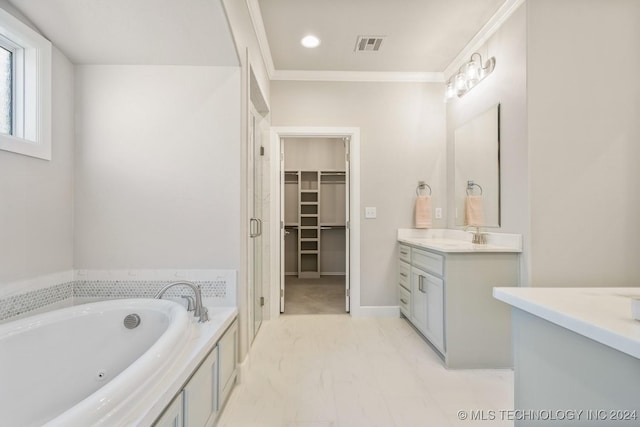 bathroom with a garden tub, crown molding, a walk in closet, vanity, and marble finish floor