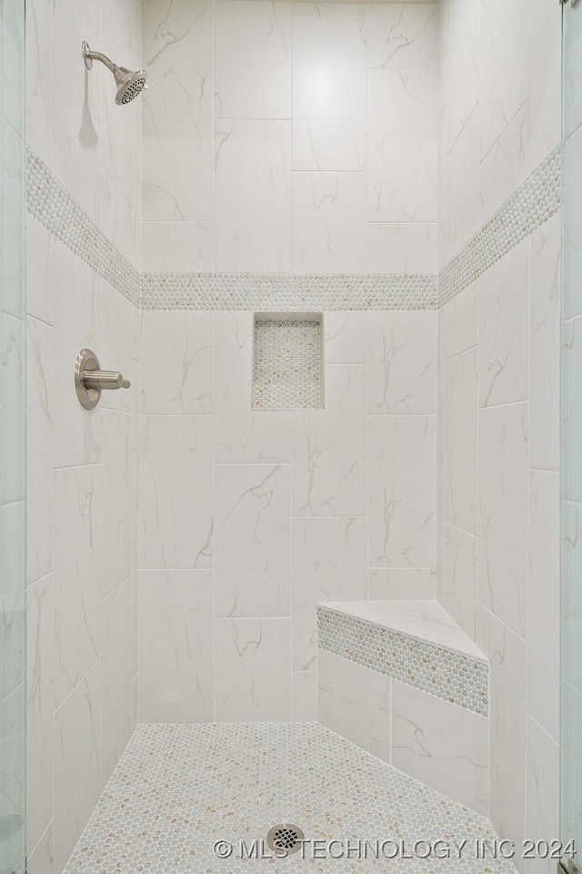 full bathroom with tiled shower