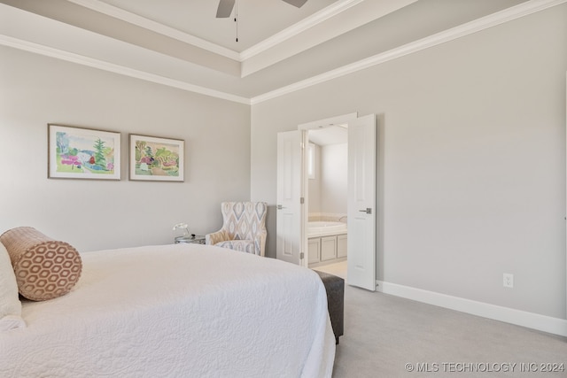 bedroom with connected bathroom, a raised ceiling, crown molding, carpet, and ceiling fan