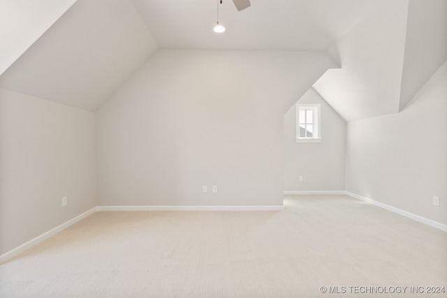 additional living space featuring ceiling fan, vaulted ceiling, and carpet flooring