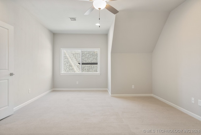 bonus room featuring ceiling fan, light colored carpet, and lofted ceiling