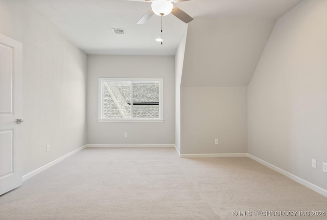 bonus room featuring baseboards, visible vents, light colored carpet, lofted ceiling, and ceiling fan