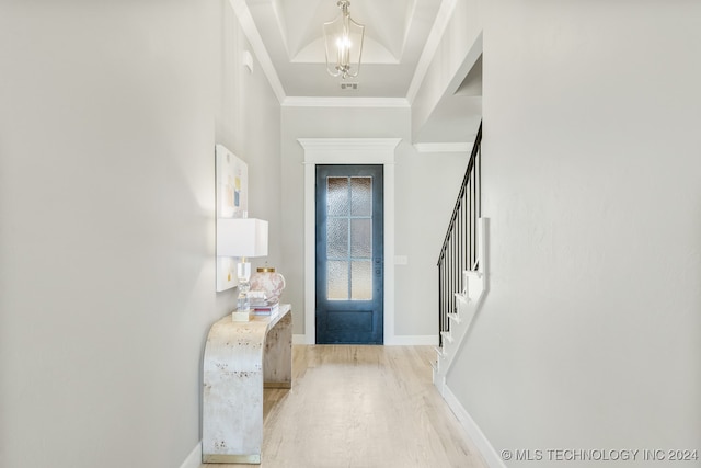 entryway with light wood-type flooring and ornamental molding