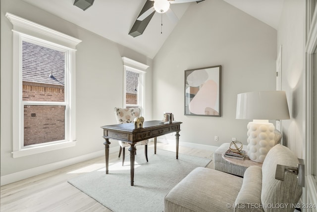 office space with high vaulted ceiling, light wood-type flooring, ceiling fan, and a wealth of natural light