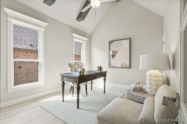 office area with a ceiling fan, baseboards, high vaulted ceiling, and a healthy amount of sunlight