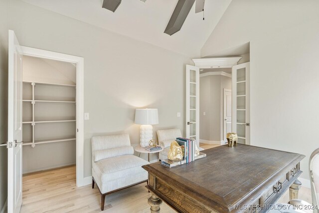 office space with high vaulted ceiling, ceiling fan, french doors, and wood finished floors