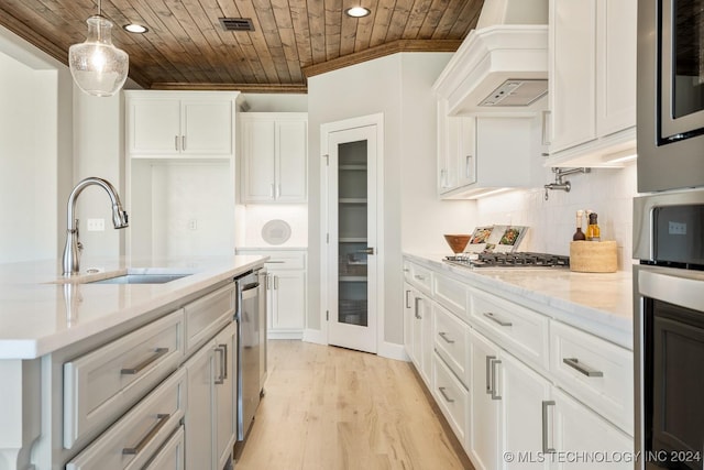 kitchen with a sink, custom exhaust hood, crown molding, wood ceiling, and appliances with stainless steel finishes