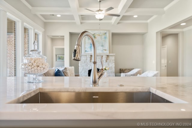 kitchen with beamed ceiling, coffered ceiling, and ceiling fan