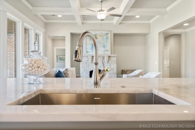 details with recessed lighting, coffered ceiling, a ceiling fan, a sink, and beamed ceiling