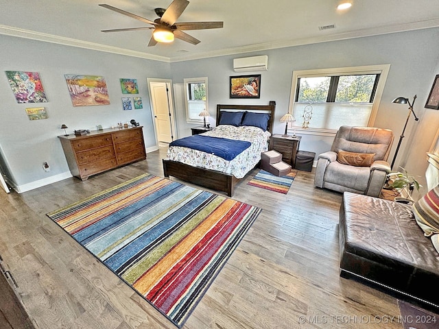 bedroom with ceiling fan, an AC wall unit, hardwood / wood-style flooring, and ornamental molding