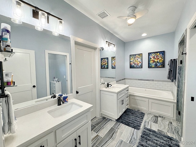 bathroom with a tub, dual vanity, tile patterned floors, and ceiling fan