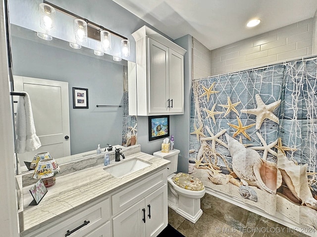 bathroom with toilet, tile patterned floors, and vanity