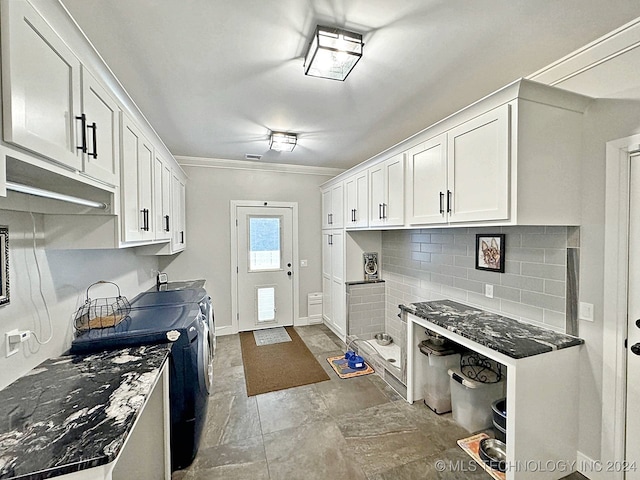 kitchen with tasteful backsplash, ornamental molding, dark stone counters, white cabinetry, and tile patterned flooring