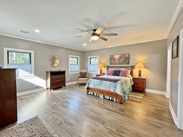 bedroom with light wood-type flooring, ornamental molding, and ceiling fan