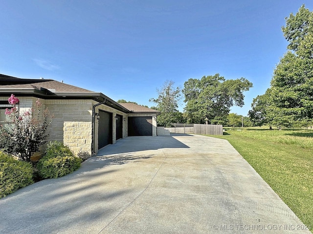 view of side of home with a yard