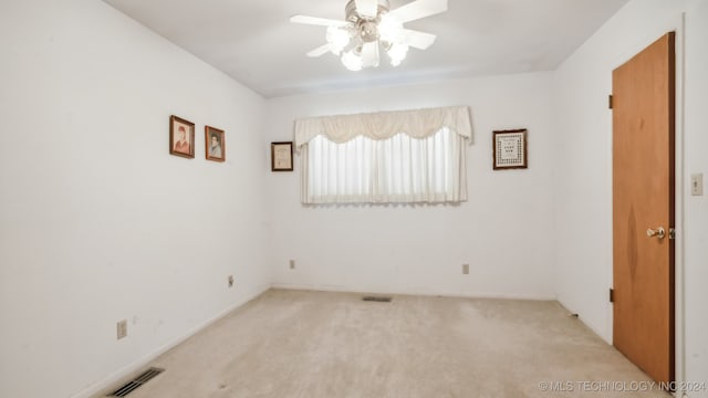 unfurnished room featuring ceiling fan and light carpet