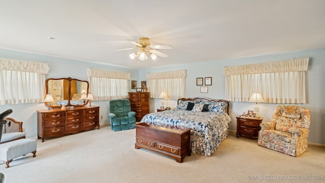 bedroom featuring light carpet and ceiling fan