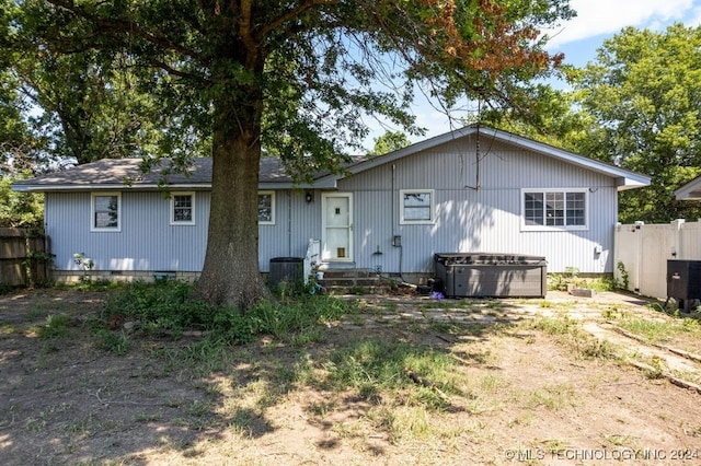 rear view of house with central air condition unit