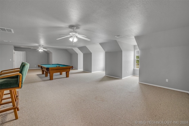 recreation room with a textured ceiling, lofted ceiling, light colored carpet, billiards, and ceiling fan