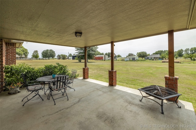 view of patio with a fire pit