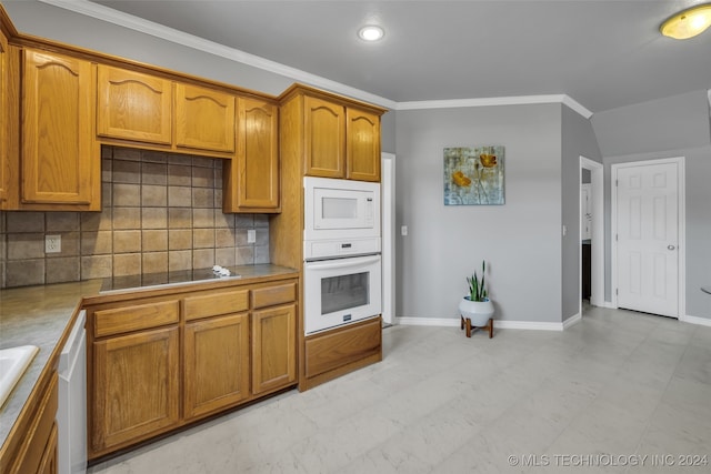 kitchen with ornamental molding, backsplash, white appliances, and light tile patterned floors