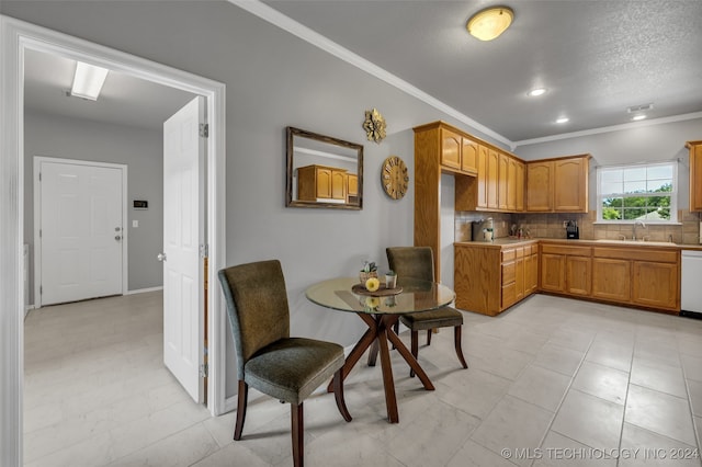 kitchen with dishwasher, ornamental molding, tasteful backsplash, sink, and light tile patterned flooring