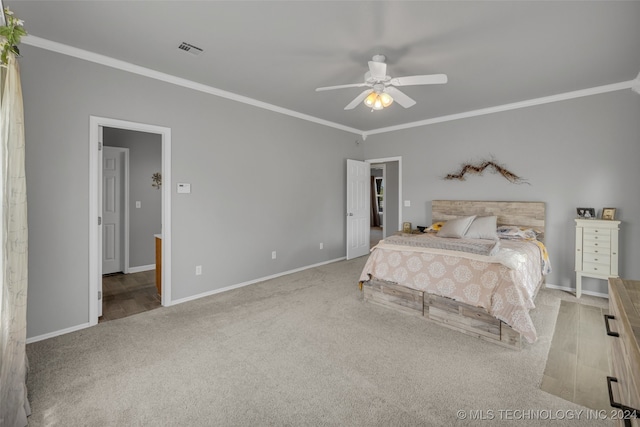 bedroom featuring ceiling fan, ornamental molding, and light carpet