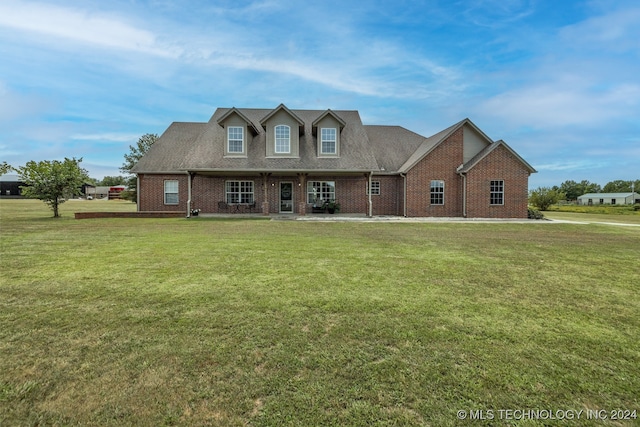 cape cod home featuring a front lawn