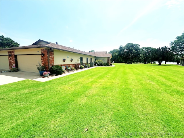 view of front of home with a front yard and a garage