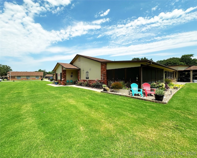 rear view of property featuring a lawn