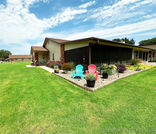 rear view of property with a yard