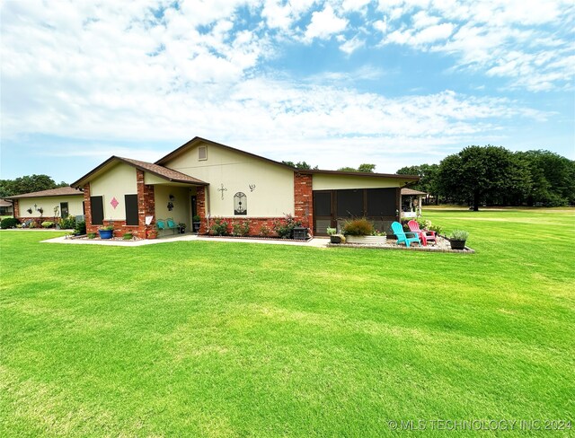 back of house with a yard and a patio area