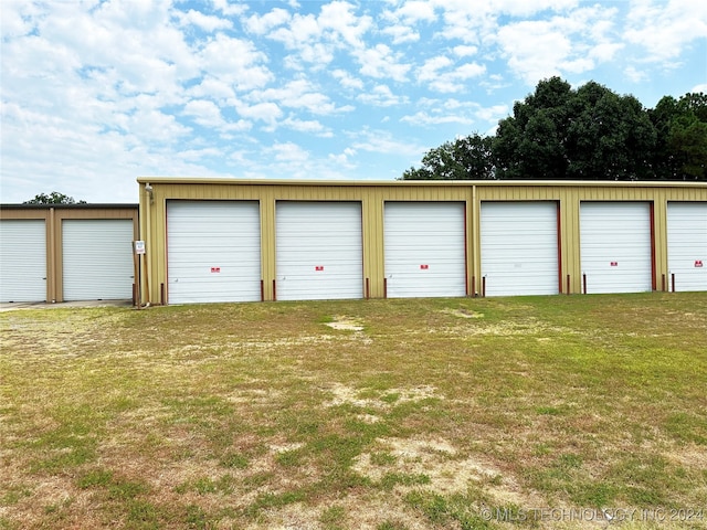 garage featuring a yard