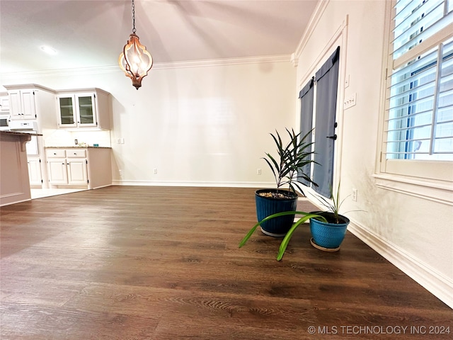 interior space featuring crown molding and dark hardwood / wood-style flooring