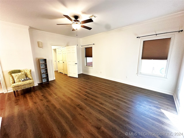 interior space featuring dark wood-type flooring, ornamental molding, and ceiling fan