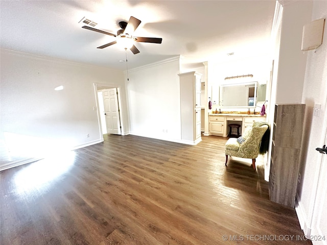 unfurnished living room featuring dark wood-type flooring, ceiling fan, and crown molding