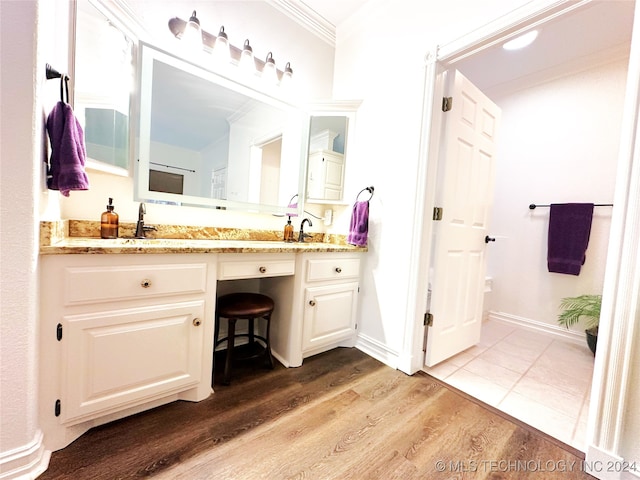 bathroom featuring crown molding, vanity, and hardwood / wood-style flooring