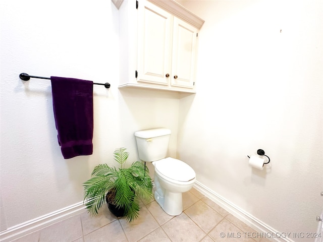 bathroom with tile patterned flooring and toilet