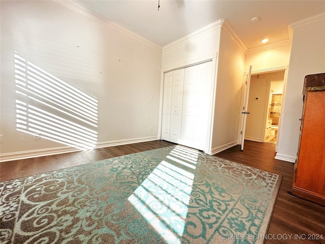 bedroom with ornamental molding, dark hardwood / wood-style floors, and a closet