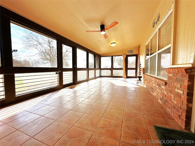 unfurnished sunroom with vaulted ceiling and ceiling fan