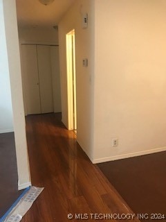 hallway with dark wood-type flooring