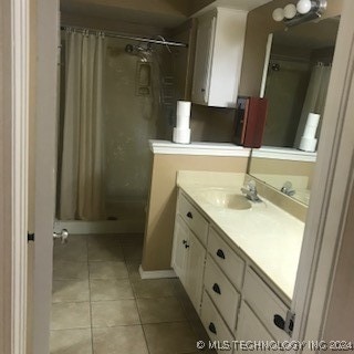 bathroom featuring tile patterned flooring, a shower with curtain, and vanity