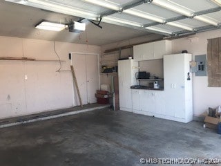 garage featuring a garage door opener and electric panel