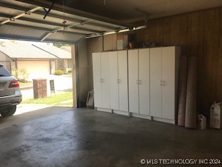 garage featuring wooden walls