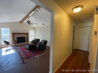 corridor with dark hardwood / wood-style flooring and vaulted ceiling with beams