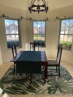 dining area with plenty of natural light and a chandelier