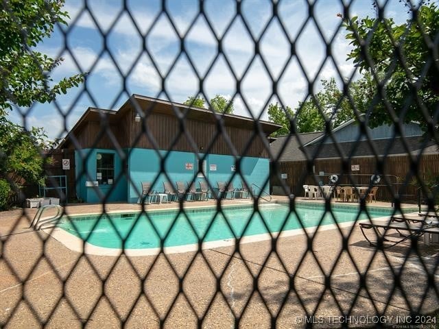 view of swimming pool featuring a patio area