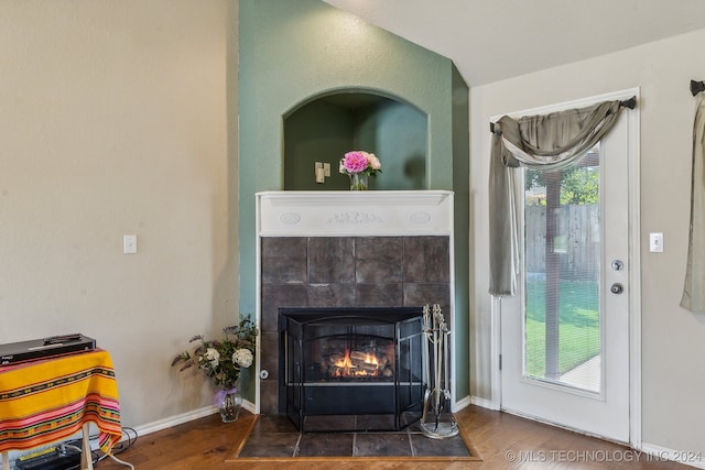 interior details with wood-type flooring and a fireplace