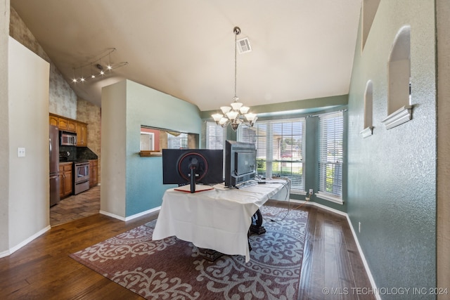 dining room with dark hardwood / wood-style floors, track lighting, a chandelier, and high vaulted ceiling